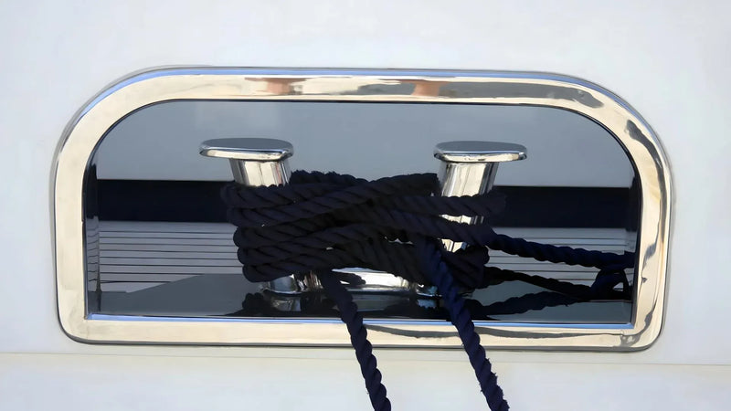 Nautical cleat with black rope on a white background