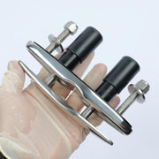 boat cleats held by a gloved hand